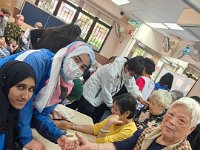 The elderly happily showing their henna